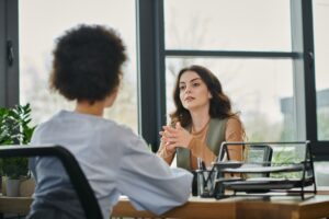 Two business professionals from HR and Finance collaborating over workforce strategy documents in a modern office, symbolizing alignment in human capital management