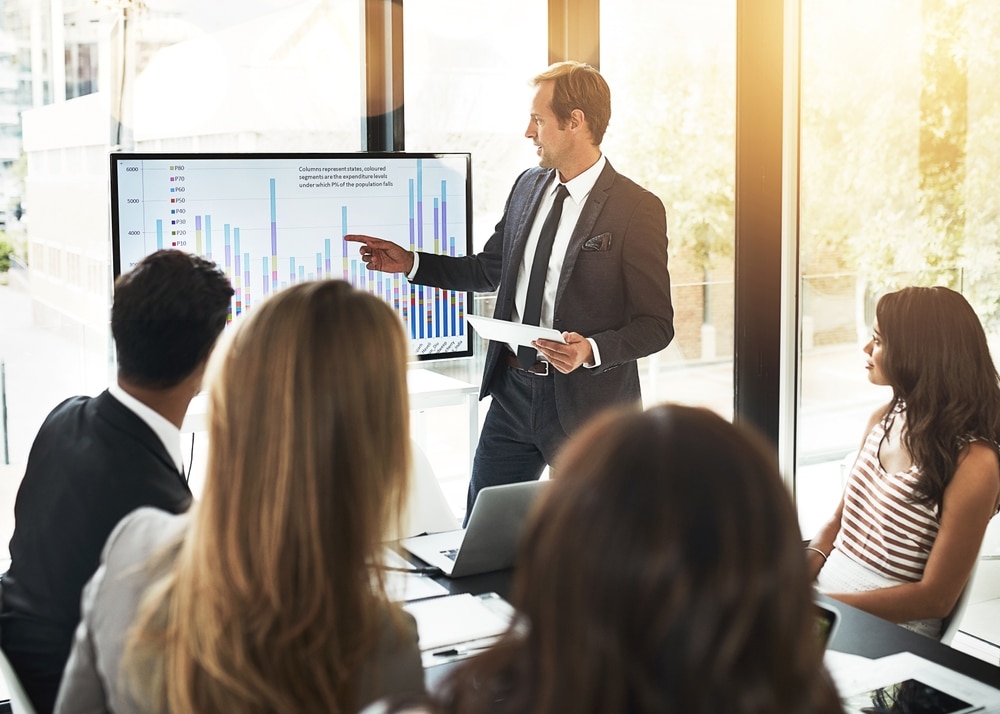 Business,People,,Conversation,And,Presentation,With,Data,On,Screen,For