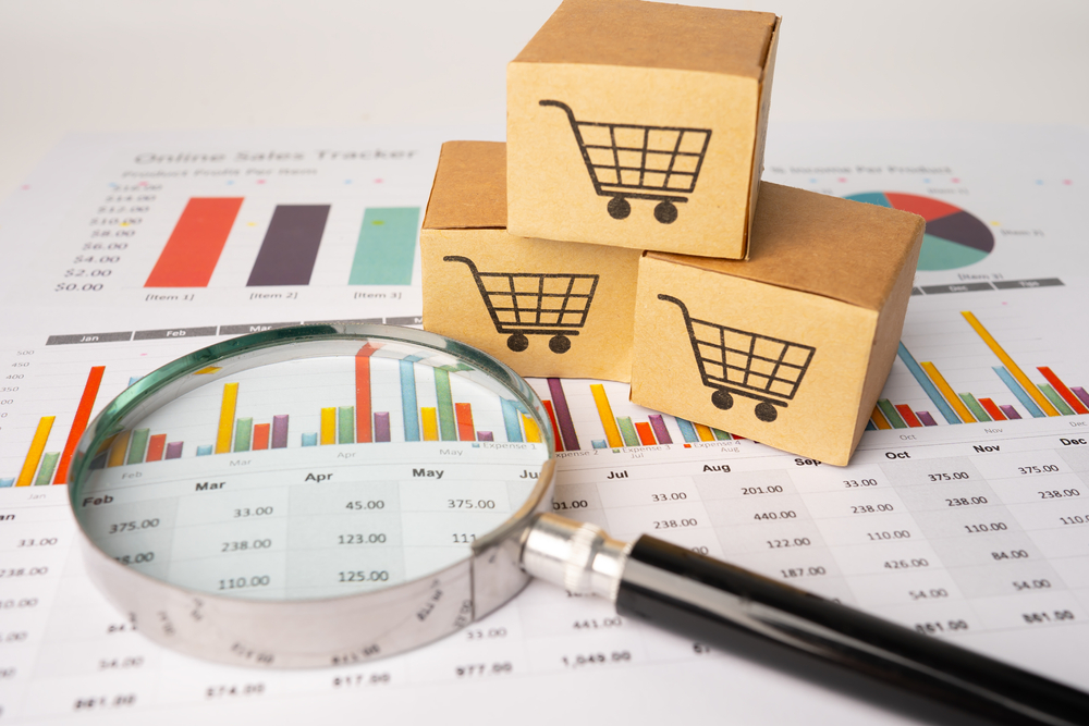Shopping,Cart,Logo,On,Box,With,Magnifying,Glass,On,Graph